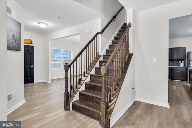 stairs with wood-type flooring