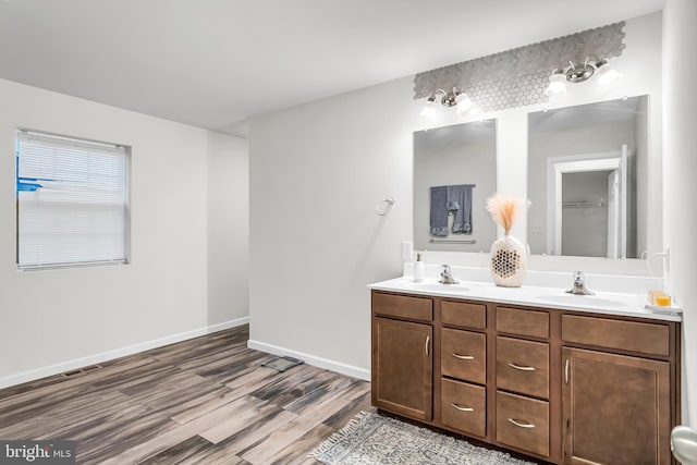 bathroom with hardwood / wood-style floors and vanity