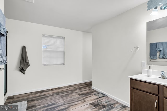 bathroom with vanity and wood-type flooring