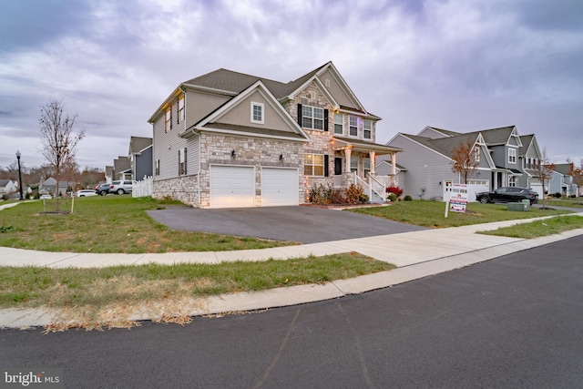 view of front of house featuring a garage and a front lawn