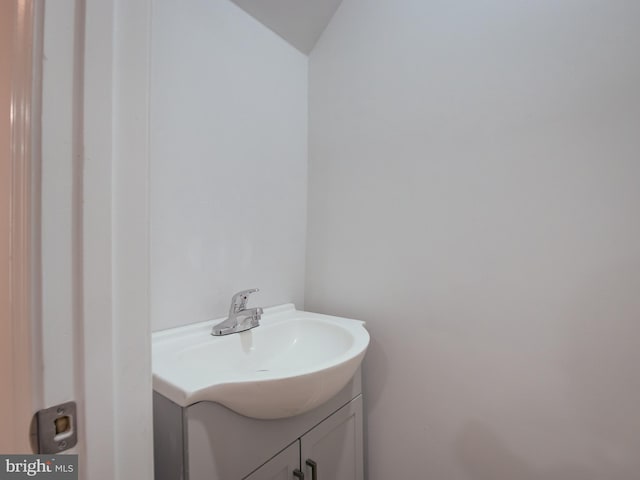 bathroom with vanity and vaulted ceiling