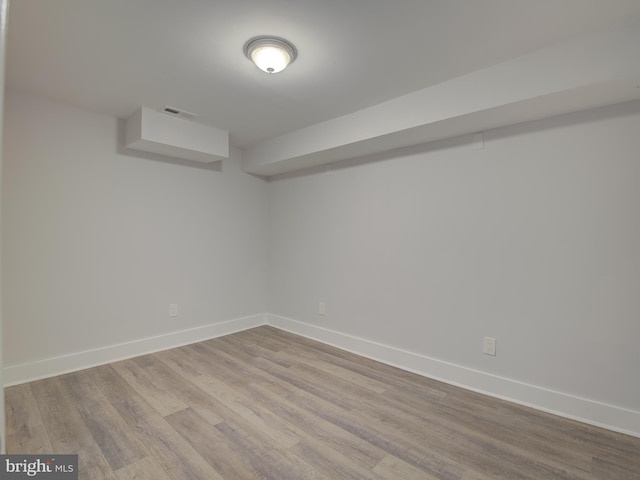 basement with light hardwood / wood-style flooring