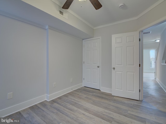 unfurnished bedroom featuring crown molding, ceiling fan, and light hardwood / wood-style floors