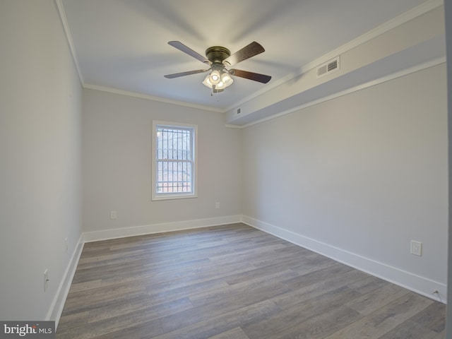 unfurnished room with hardwood / wood-style flooring, ceiling fan, and crown molding