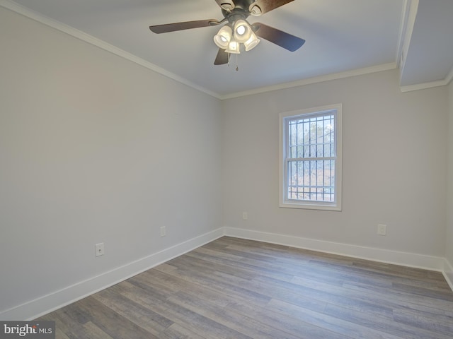 empty room featuring wood-type flooring, ceiling fan, and ornamental molding