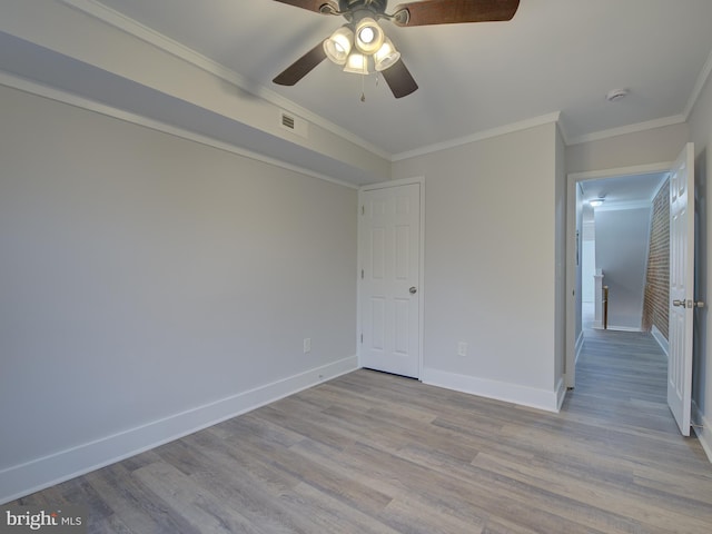 unfurnished bedroom with ceiling fan, light wood-type flooring, and ornamental molding