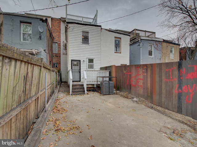 rear view of house featuring central AC unit