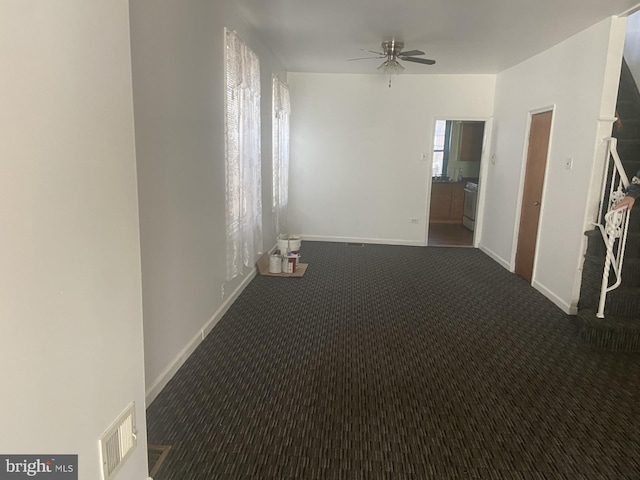 carpeted spare room featuring ceiling fan