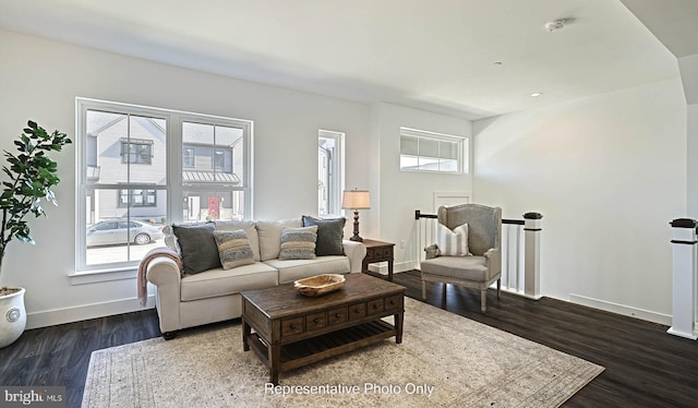 living room featuring dark hardwood / wood-style floors and a healthy amount of sunlight