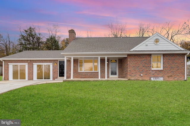 view of front of house featuring a garage and a yard