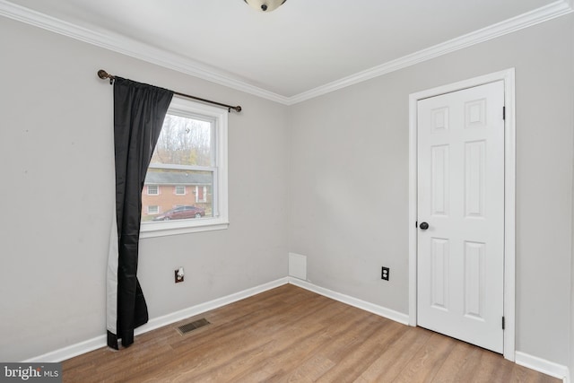 unfurnished room featuring crown molding and light hardwood / wood-style floors