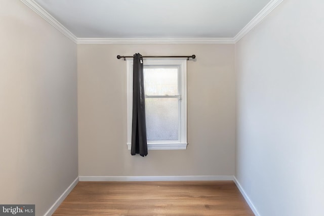 unfurnished room with ornamental molding and light wood-type flooring