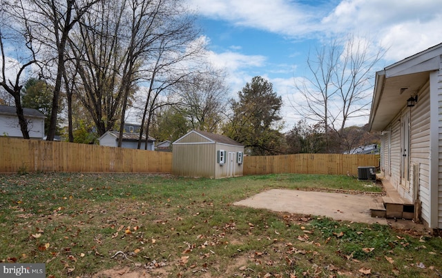 view of yard with central AC unit, a storage unit, and a patio