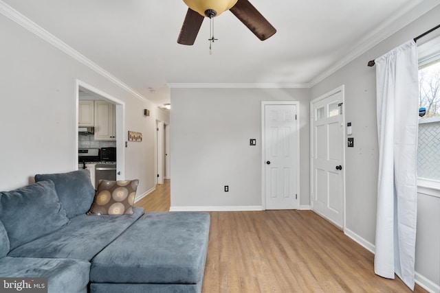 living room with light hardwood / wood-style floors, ceiling fan, and crown molding