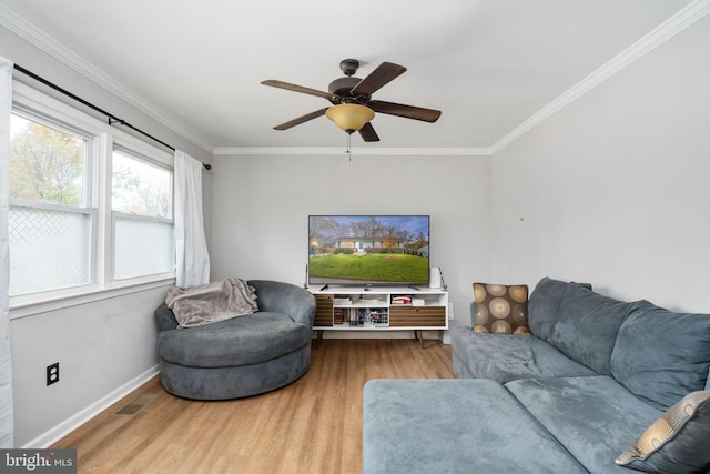 living room with hardwood / wood-style flooring, ceiling fan, and ornamental molding