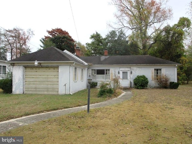 ranch-style home with a garage and a front yard