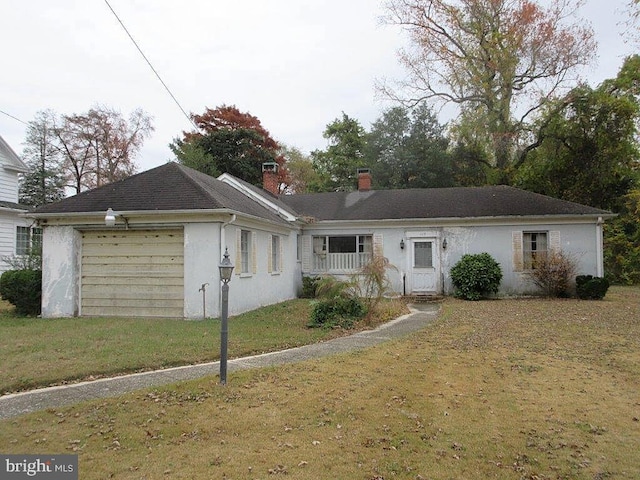 ranch-style home with a garage and a front yard