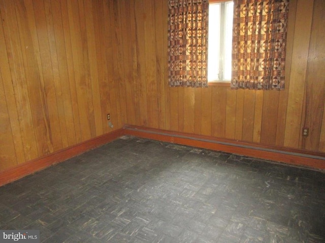 empty room featuring wood walls