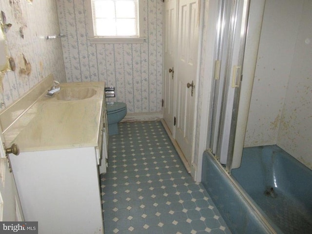 full bathroom with toilet, vanity, and combined bath / shower with glass door