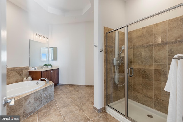 bathroom with tile patterned floors, vanity, and plus walk in shower