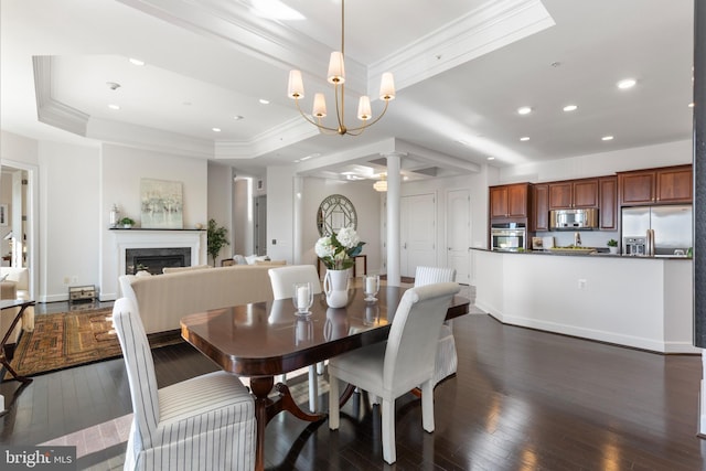 dining space featuring a raised ceiling, a chandelier, and dark wood-type flooring