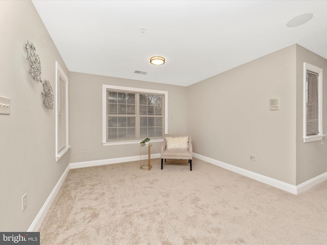 unfurnished room featuring light colored carpet