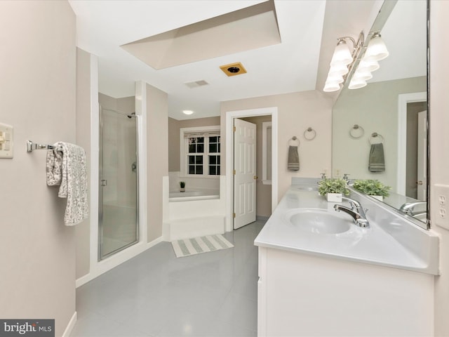 bathroom with tile patterned floors, separate shower and tub, and vanity