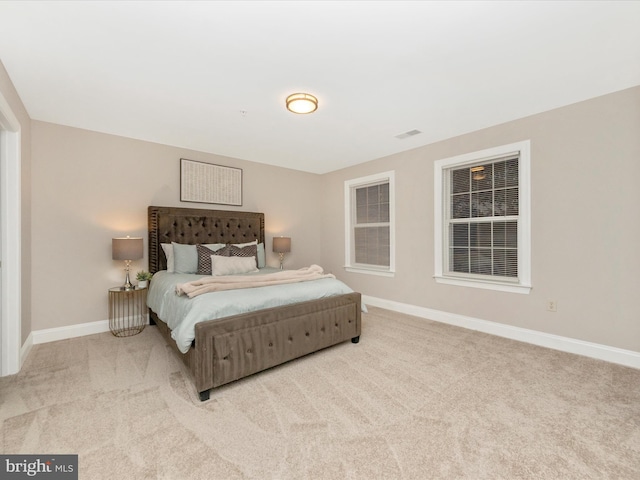 bedroom with light colored carpet