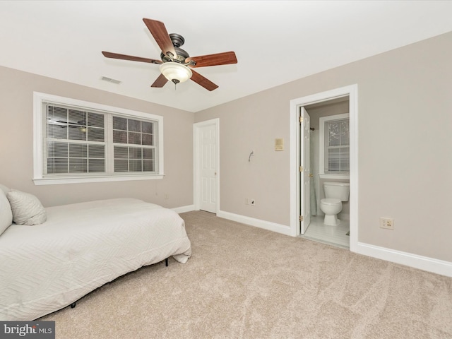 carpeted bedroom featuring ensuite bathroom and ceiling fan