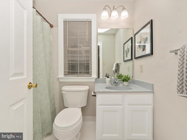 bathroom with tile patterned floors, vanity, and toilet