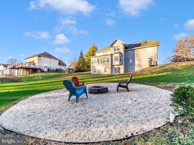 surrounding community featuring a yard, an outdoor fire pit, and a patio area