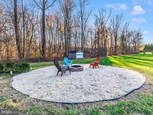 view of patio featuring a shed and an outdoor fire pit