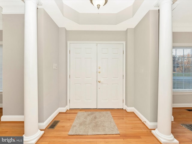 entryway featuring hardwood / wood-style flooring and ornate columns