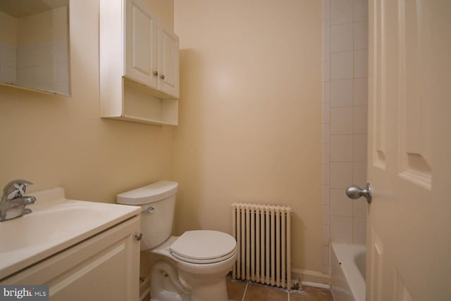 full bathroom with vanity, radiator, tile patterned floors, tiled shower / bath combo, and toilet