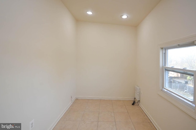 tiled empty room with lofted ceiling