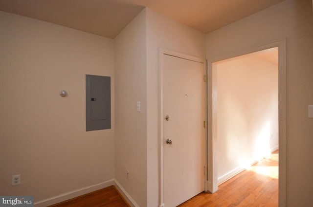 corridor featuring wood-type flooring and electric panel