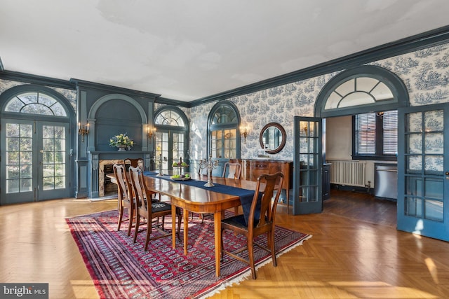 dining area featuring radiator heating unit, french doors, dark parquet floors, and ornamental molding