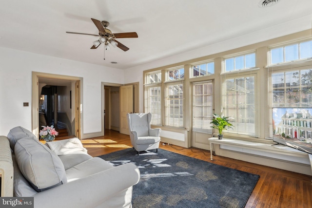 living room with ceiling fan and hardwood / wood-style floors