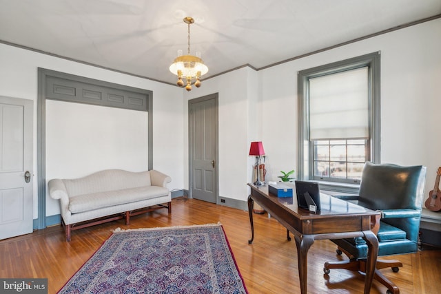 office area featuring wood-type flooring and an inviting chandelier