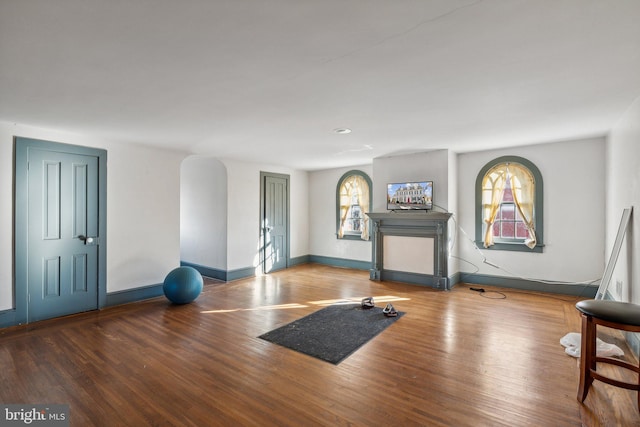 exercise room with wood-type flooring