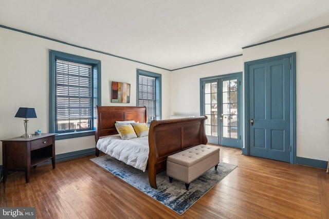 bedroom featuring access to exterior, french doors, and wood-type flooring