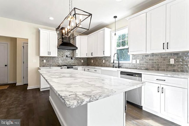 kitchen with dishwasher, pendant lighting, white cabinetry, and a kitchen island