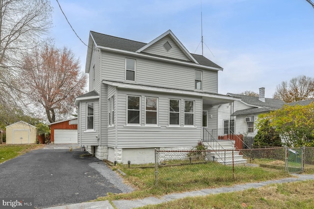 front of property with an outdoor structure and a garage