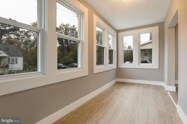 unfurnished sunroom featuring a wealth of natural light