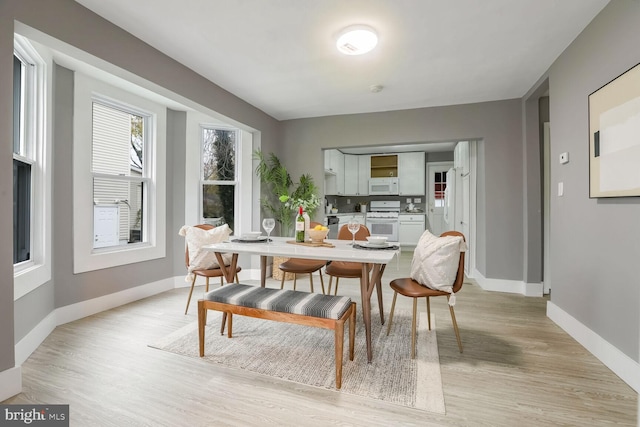 dining space with light hardwood / wood-style floors