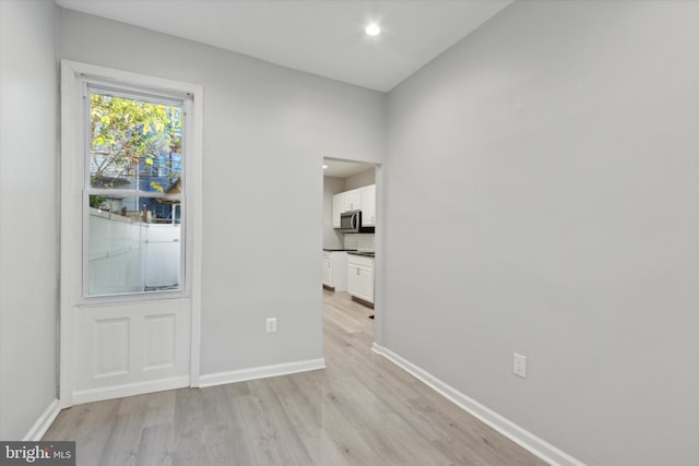 spare room with light hardwood / wood-style floors