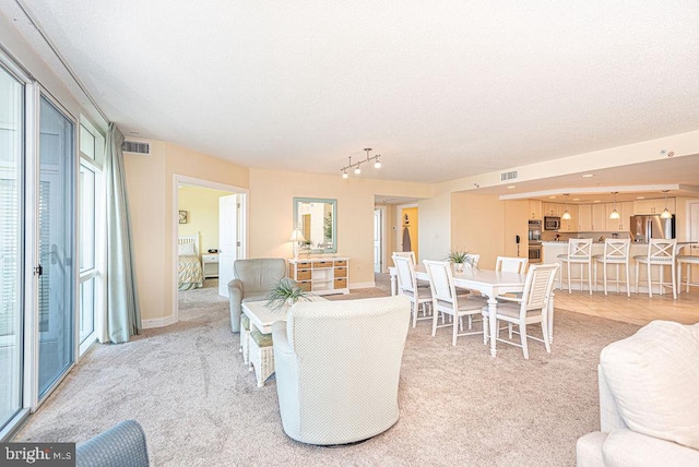 dining area featuring light carpet