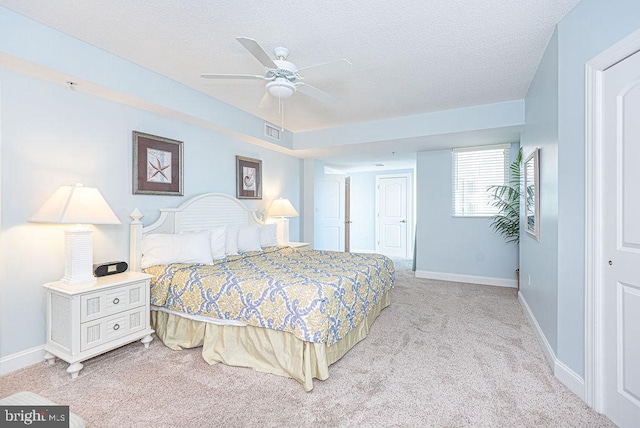 carpeted bedroom featuring ceiling fan, a textured ceiling, and a closet