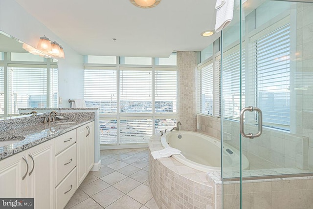 bathroom featuring tile patterned flooring, vanity, plenty of natural light, and independent shower and bath