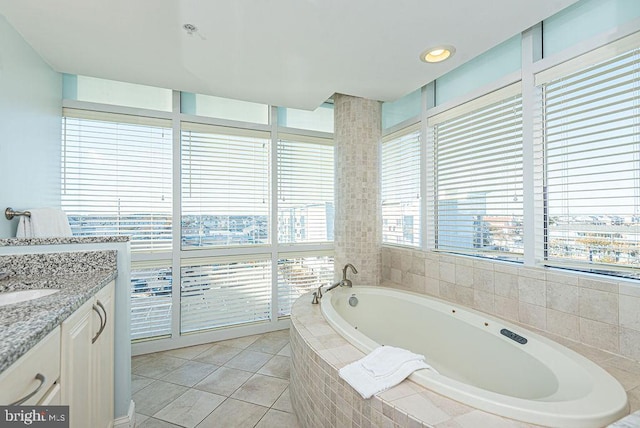 bathroom with vanity, tiled bath, and tile patterned floors